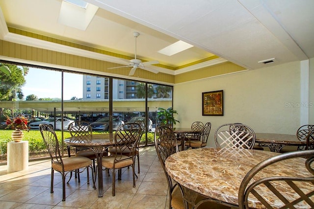 2621 Cove Cay Dr Unit 302, Clearwater, FL 33760 - dining space with a raised ceiling, light tile patterned flooring, a skylight, and a ceiling fan
