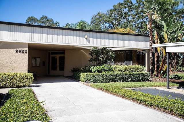 2621 Cove Cay Dr Unit 302, Clearwater, FL 33760 - view of property featuring concrete driveway and an attached carport