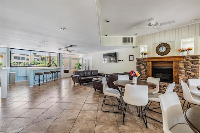 2621 Cove Cay Dr Unit 302, Clearwater, FL 33760 - dining room featuring a ceiling fan, a stone fireplace, and tile patterned flooring
