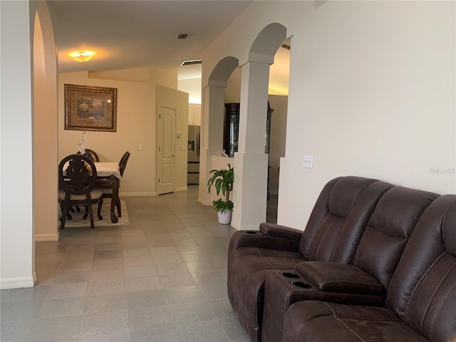 11513 Andy Dr, Riverview, FL 33569 - living room featuring arched walkways, lofted ceiling, baseboards, and ornate columns