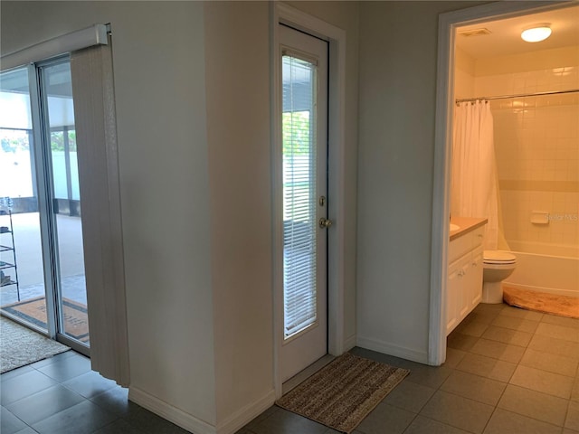 11513 Andy Dr, Riverview, FL 33569 - doorway with tile patterned floors and baseboards