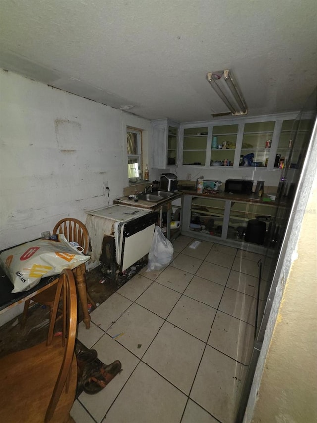 5800 SE 33rd Ave, Ocala, FL 34480 - kitchen with light tile patterned flooring, a textured ceiling, and a sink