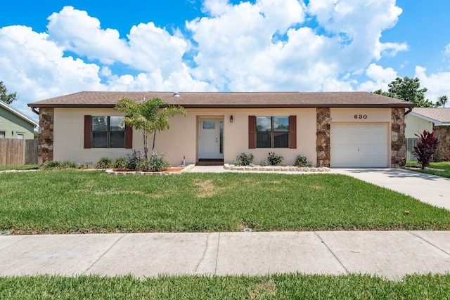 630 Kirkland Cir, Dunedin, FL 34698 - single story home featuring an attached garage, concrete driveway, stone siding, and stucco siding