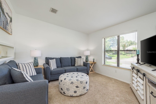 630 Kirkland Cir, Dunedin, FL 34698 - living room with baseboards and light colored carpet
