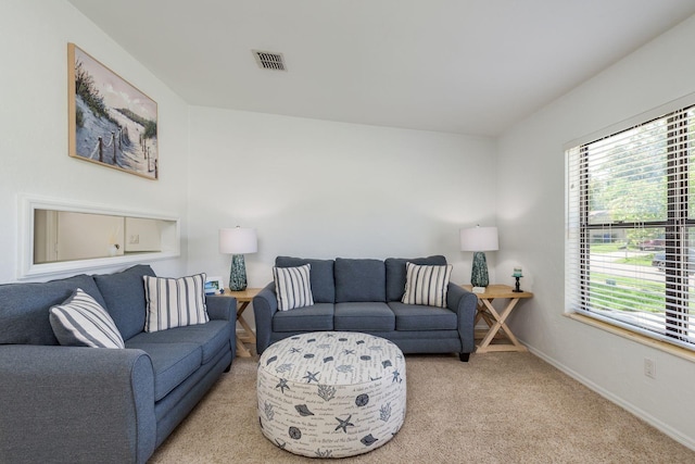 630 Kirkland Cir, Dunedin, FL 34698 - living room featuring light colored carpet and plenty of natural light