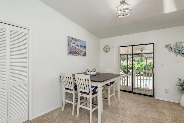 630 Kirkland Cir, Dunedin, FL 34698 - dining room featuring carpet floors and a chandelier