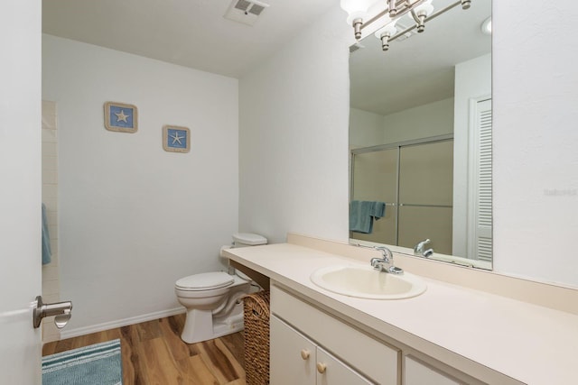630 Kirkland Cir, Dunedin, FL 34698 - bathroom with wood finished floors, vanity, and a shower with shower door
