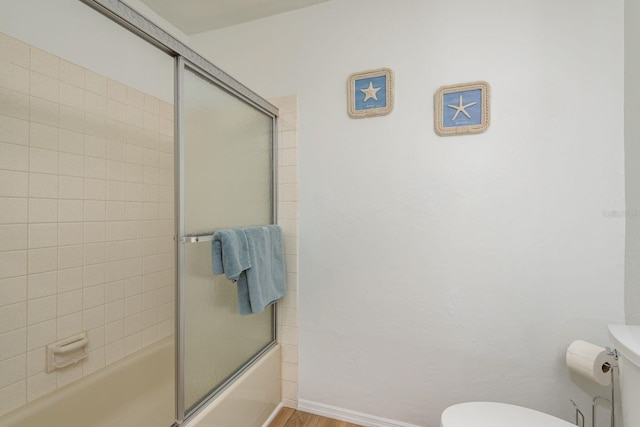 630 Kirkland Cir, Dunedin, FL 34698 - full bathroom featuring shower / bath combination with glass door and wood finished floors