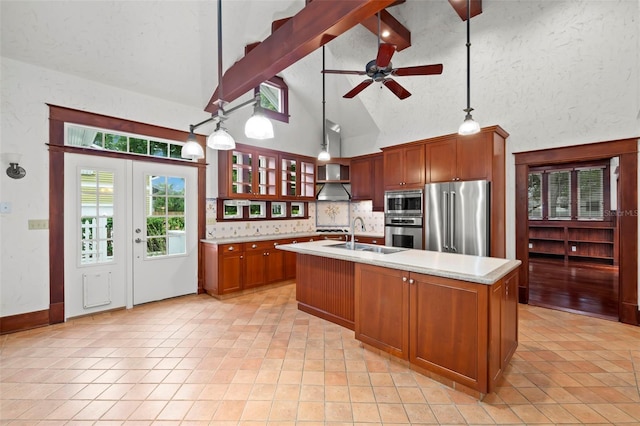 1400 Cherry St NE, Saint Petersburg, FL 33704 - kitchen with stainless steel appliances, a sink, light countertops, a ceiling fan, and a center island with sink