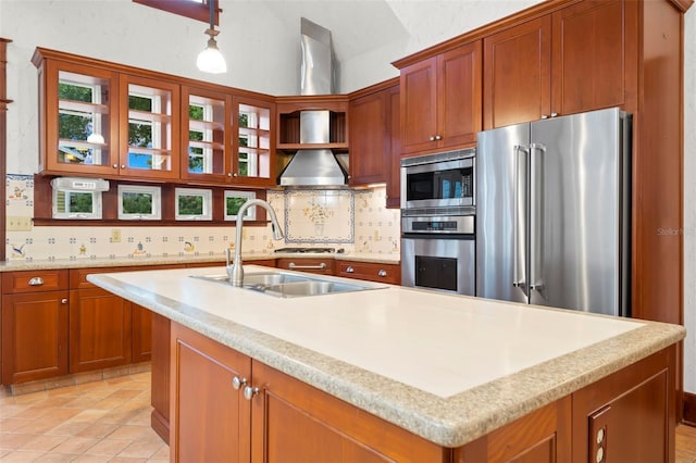 1400 Cherry St NE, Saint Petersburg, FL 33704 - kitchen featuring appliances with stainless steel finishes, decorative backsplash, an island with sink, a sink, and vaulted ceiling