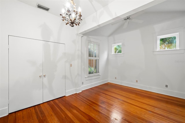 1400 Cherry St NE, Saint Petersburg, FL 33704 - unfurnished bedroom with a chandelier, baseboards, wood finished floors, and lofted ceiling