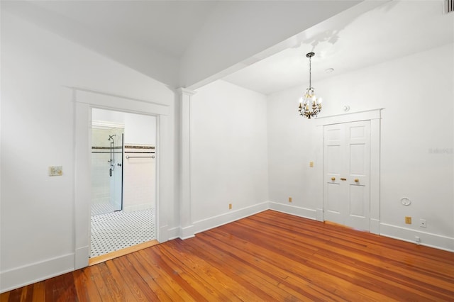 1400 Cherry St NE, Saint Petersburg, FL 33704 - spare room with a chandelier, light wood finished floors, and baseboards