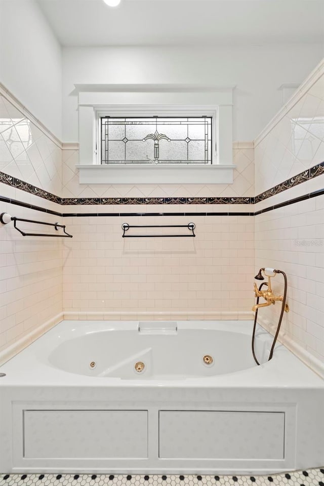1400 Cherry St NE, Saint Petersburg, FL 33704 - bathroom featuring a jetted tub and tile walls