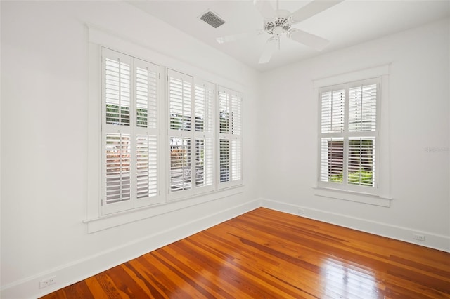 1400 Cherry St NE, Saint Petersburg, FL 33704 - empty room with plenty of natural light, wood finished floors, baseboards, and a ceiling fan