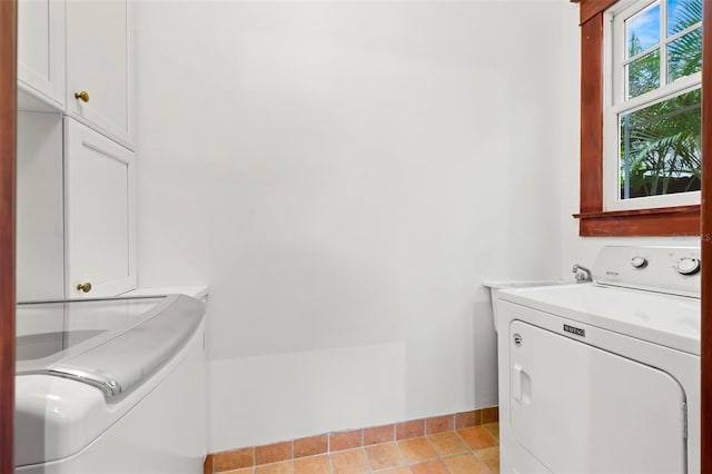 1400 Cherry St NE, Saint Petersburg, FL 33704 - laundry room featuring cabinet space, washer and clothes dryer, baseboards, and light tile patterned floors