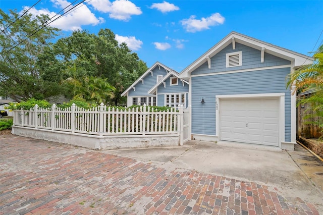 1400 Cherry St NE, Saint Petersburg, FL 33704 - view of front of property with a garage and driveway