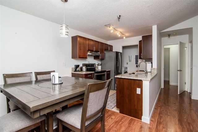 10265 Gandy Blvd N Unit 1702, Saint Petersburg, FL 33702 - kitchen featuring stainless steel appliances, a sink, under cabinet range hood, wood finished floors, and a textured ceiling