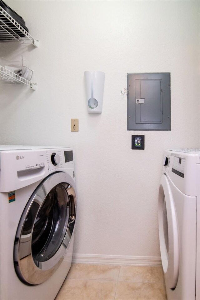 10265 Gandy Blvd N Unit 1702, Saint Petersburg, FL 33702 - laundry room featuring electric panel, baseboards, separate washer and dryer, and light tile patterned floors