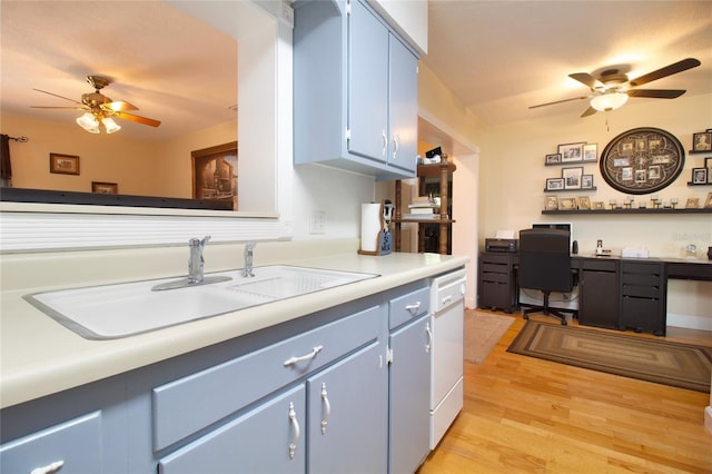 2010 6th Ave SW, Largo, FL 33770 - kitchen featuring a ceiling fan, a sink, blue cabinetry, and light wood-style floors