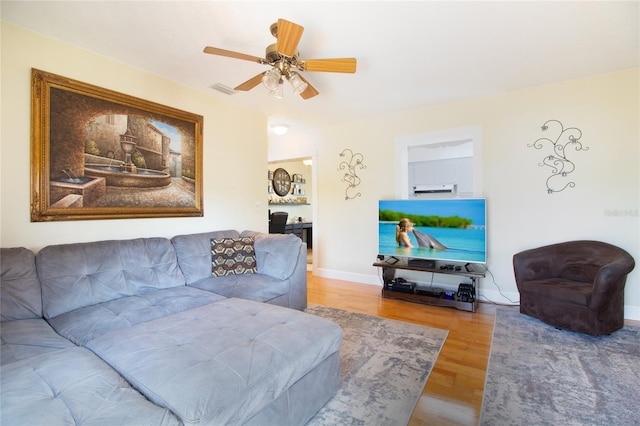 2010 6th Ave SW, Largo, FL 33770 - living area featuring wood finished floors, a ceiling fan, and baseboards