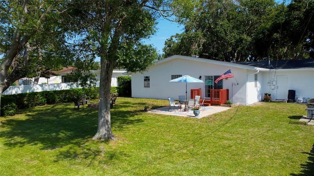 2010 6th Ave SW, Largo, FL 33770 - back of property with a patio, a yard, and stucco siding
