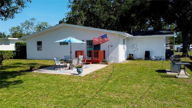 2010 6th Ave SW, Largo, FL 33770 - back of property featuring a patio, stucco siding, and a lawn
