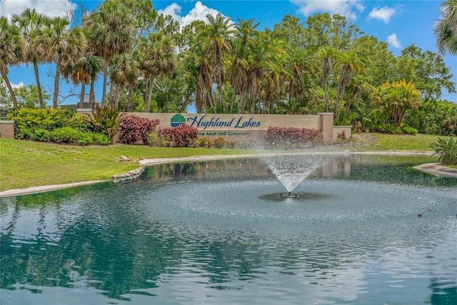 1401 Camelot Ct, Palm Harbor, FL 34684 - community / neighborhood sign featuring a water view and a lawn