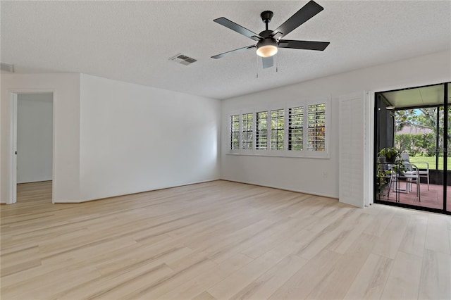 1401 Camelot Ct, Palm Harbor, FL 34684 - empty room featuring light wood-style flooring, a textured ceiling, and a ceiling fan
