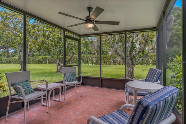 1401 Camelot Ct, Palm Harbor, FL 34684 - sunroom with a ceiling fan, plenty of natural light, and view of wooded area