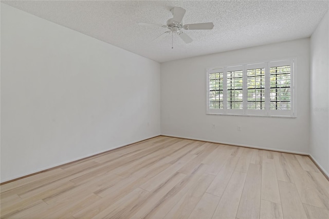1401 Camelot Ct, Palm Harbor, FL 34684 - unfurnished room with light wood-type flooring, a textured ceiling, and ceiling fan