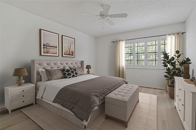 1401 Camelot Ct, Palm Harbor, FL 34684 - bedroom with a textured ceiling, light wood-style floors, and ceiling fan
