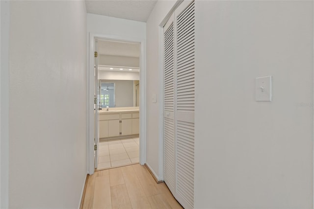 1401 Camelot Ct, Palm Harbor, FL 34684 - hall with light wood-type flooring and baseboards