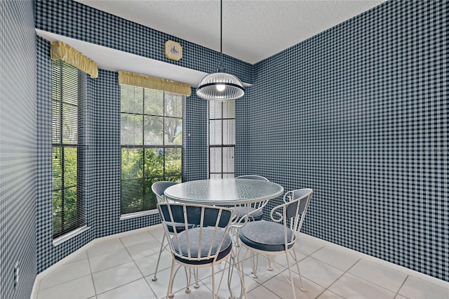 1401 Camelot Ct, Palm Harbor, FL 34684 - dining room featuring wallpapered walls, a textured ceiling, tile patterned floors, and baseboards