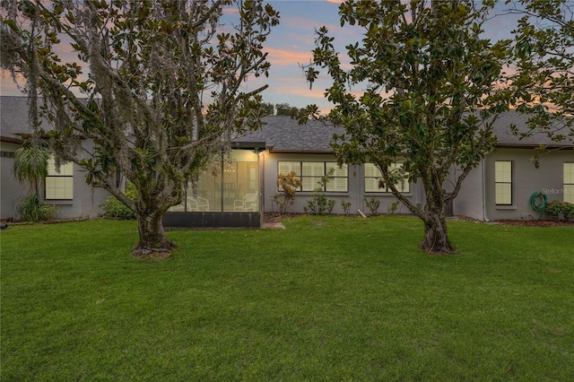 1401 Camelot Ct, Palm Harbor, FL 34684 - view of front of property featuring stucco siding, a yard, and a shingled roof