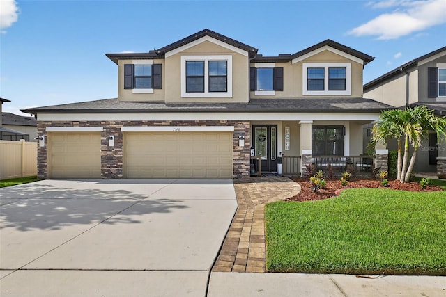 7570 Sweeter Tide Trl, Wesley Chapel, FL 33545 - view of front of house featuring stucco siding, covered porch, concrete driveway, an attached garage, and a front yard