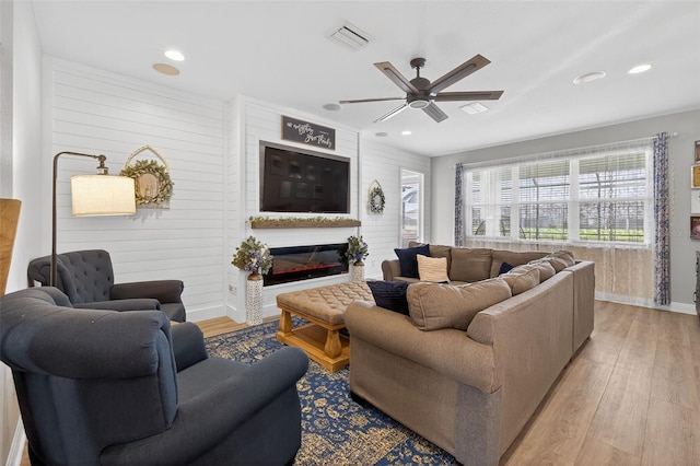 7570 Sweeter Tide Trl, Wesley Chapel, FL 33545 - living room featuring light wood-type flooring, ceiling fan, recessed lighting, and a glass covered fireplace
