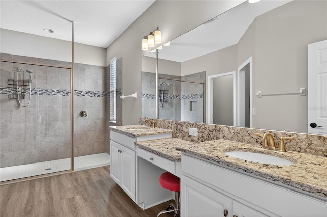 7570 Sweeter Tide Trl, Wesley Chapel, FL 33545 - bathroom featuring vanity, tiled shower, and wood finished floors
