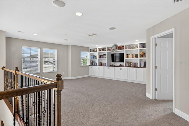 7570 Sweeter Tide Trl, Wesley Chapel, FL 33545 - living area with carpet floors, recessed lighting, and an upstairs landing