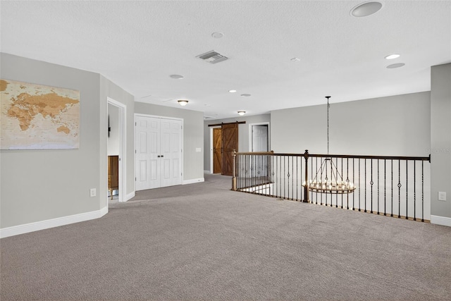 7570 Sweeter Tide Trl, Wesley Chapel, FL 33545 - spare room with carpet, a barn door, recessed lighting, and a chandelier