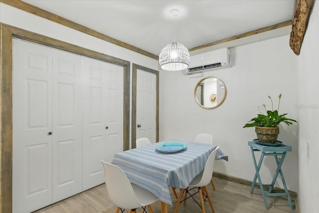 511 1st St, Cedar Key, FL 32625 - dining space with a wall mounted air conditioner and light wood-type flooring