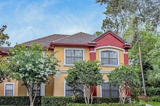 2171 Portofino Pl Unit 27-2725, Palm Harbor, FL 34683 - view of front of home with a tile roof and stucco siding