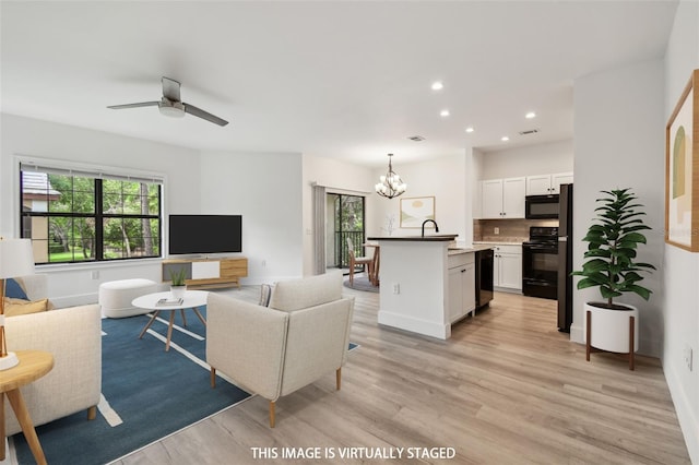 2171 Portofino Pl Unit 27-2725, Palm Harbor, FL 34683 - living room featuring a chandelier, light wood-type flooring, recessed lighting, ceiling fan, and baseboards