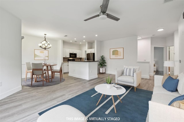 2171 Portofino Pl Unit 27-2725, Palm Harbor, FL 34683 - living area with light wood-type flooring, recessed lighting, a ceiling fan, and baseboards