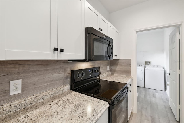 2171 Portofino Pl Unit 27-2725, Palm Harbor, FL 34683 - kitchen featuring black appliances, washing machine and dryer, white cabinets, backsplash, and light stone countertops
