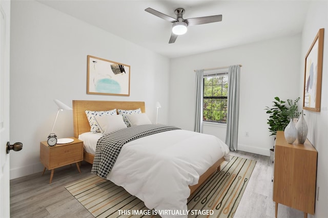 2171 Portofino Pl Unit 27-2725, Palm Harbor, FL 34683 - bedroom featuring light wood-style flooring, baseboards, and ceiling fan