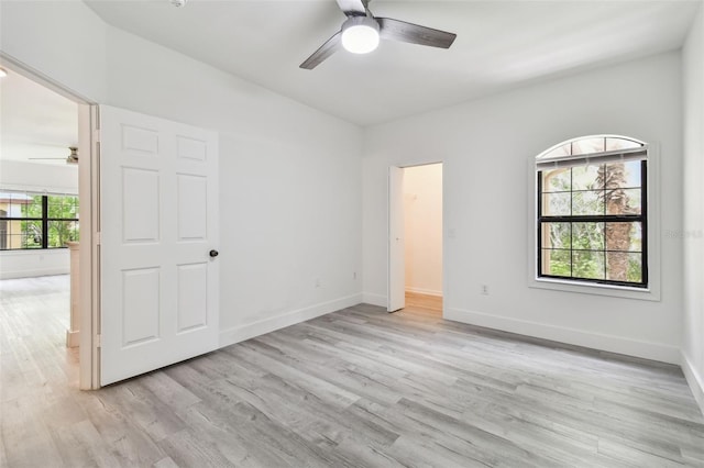 2171 Portofino Pl Unit 27-2725, Palm Harbor, FL 34683 - unfurnished bedroom with light wood-style floors, baseboards, ceiling fan, and lofted ceiling