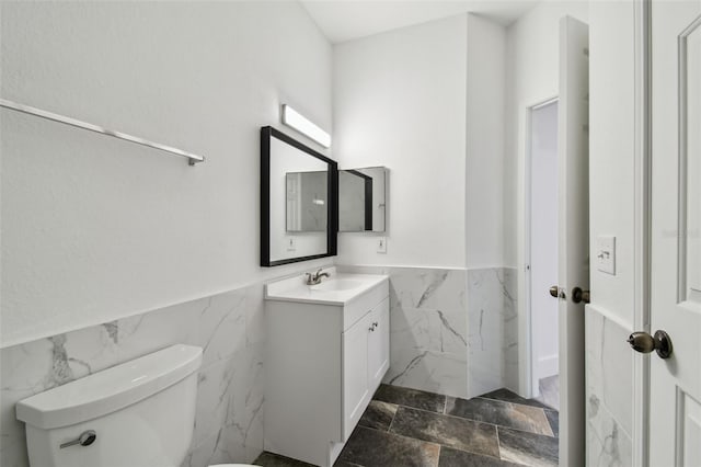 2171 Portofino Pl Unit 27-2725, Palm Harbor, FL 34683 - bathroom with tile walls, vanity, a wainscoted wall, and toilet