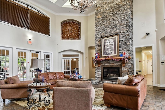 2171 Portofino Pl Unit 27-2725, Palm Harbor, FL 34683 - living room featuring a high ceiling, a chandelier, a stone fireplace, crown molding, and baseboards
