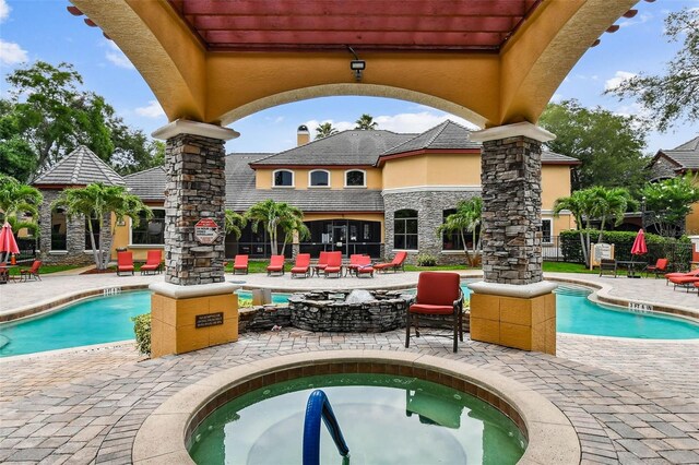 2171 Portofino Pl Unit 27-2725, Palm Harbor, FL 34683 - community pool featuring a patio area and a jacuzzi