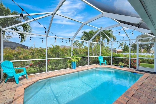 28 SW 21st Ave, Cape Coral, FL 33991 - outdoor pool featuring glass enclosure and a patio area